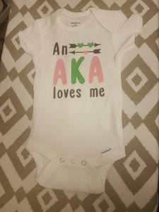 An AKA Loves Me Baby Body Suit